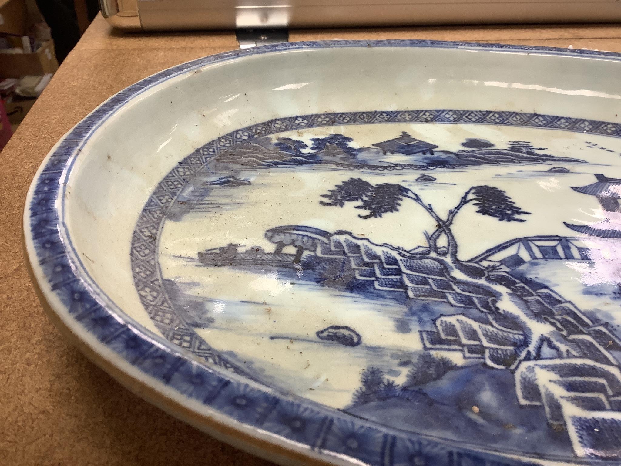 An 18th century Chinese export oval blue and white dish, 32cm.